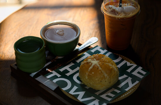 Fast Food Breakfast with Coffee and Pastry on Wooden Table in Bright Cafe
