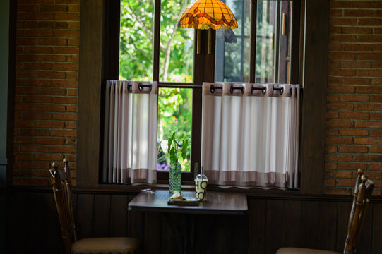 Cozy rustic living room with window view, wooden furniture, and vintage decor
