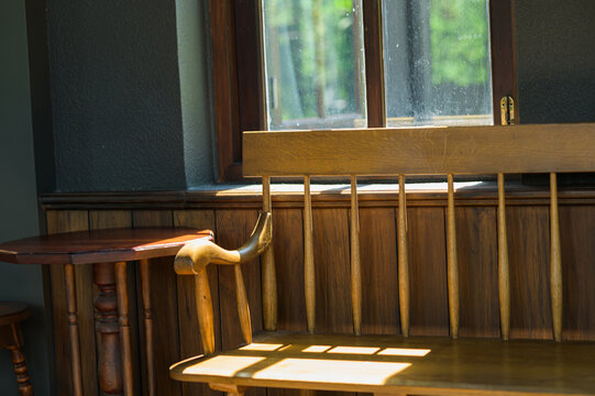 Cozy Wooden Window Alcove with Sunlight and Shadow Play in Natural Light