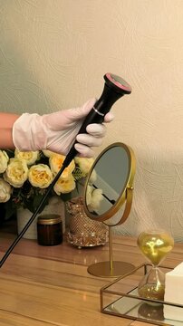 Facial treatment handpiece is displayed against an elegant spa background, professional beauty equipment, cosmetic technology, salon presentation.
