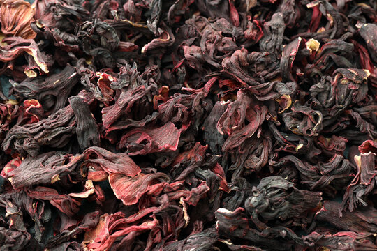 Detailed view on dry egyptian hibiscus tea in big pile on table close up