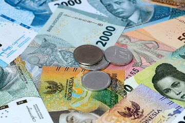 Indonesian rupiah money banknotes and coins on table. Indonesia cash bills of IDR currency © Viktor