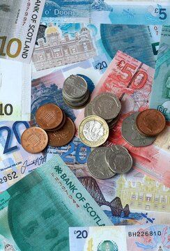 Scottish pound money banknotes and coins on table. Scotland cash bills of GBP currency