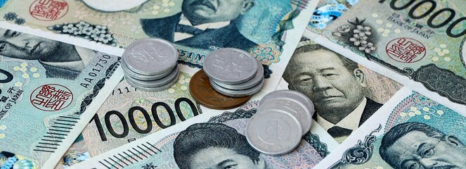 Japanese yen money banknotes and coins on table. Japan cash bills of JPY currency © Viktor