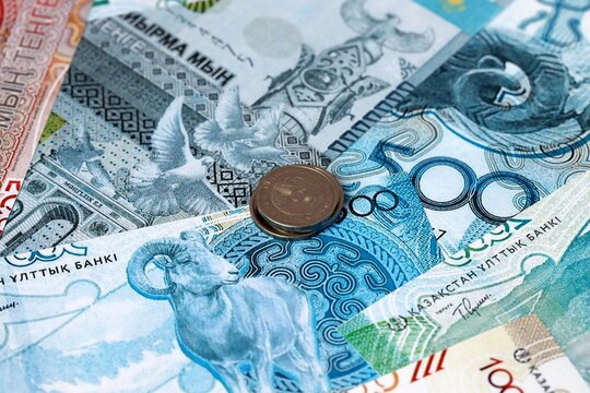 Kazakhstani tenge money banknotes and coins on table. Kazakhstan cash bills of KZT currency