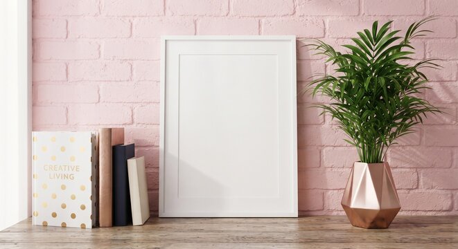 Front view vertical white frame mockup on wooden surface against pink brick wall with books and potted plant. Under 170 characters.