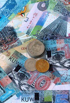 Kuwaiti dinar money banknotes and coins on table. Kuwait cash bills of KWD currency