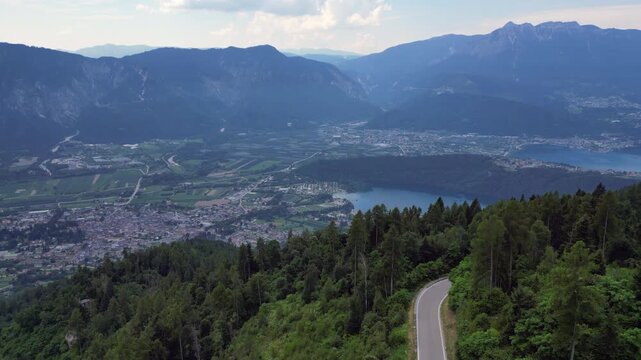 4K aerial drone footage showcasing the mountainous landscape surrounding Levico Terme in the Valsugana Valley, Trentino, northern Italy.