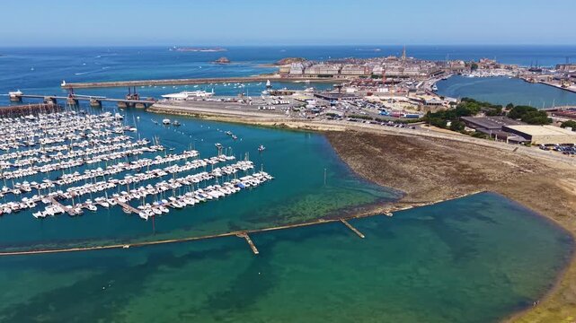 Port des Sablons Marina borders Plage des Bas Sablons beside Saint-Servan, Port de Saint-Malo, Intra-Muros, Mayenne Department, Brittany, France, overlooking the English Channel, drone lateral slide.