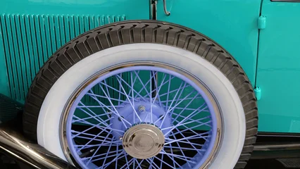 A spare whitewall tire on a vintage car .Originating in the early 1900s, this style of tyre used a white byproduct of rubber production to create the white wall look . © T.C.
