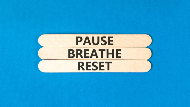 Pause breathe reset words symbol. Concept words Pause breathe reset on beautiful wooden sticks. Beautiful blue background. Business support motivational and pause breathe reset concept. Copy space.