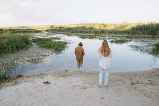 Female friends exploring nature along riverbank
