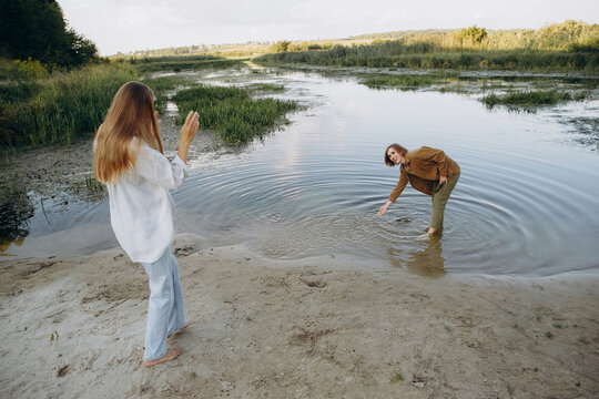 Two young women enjoying nature by river