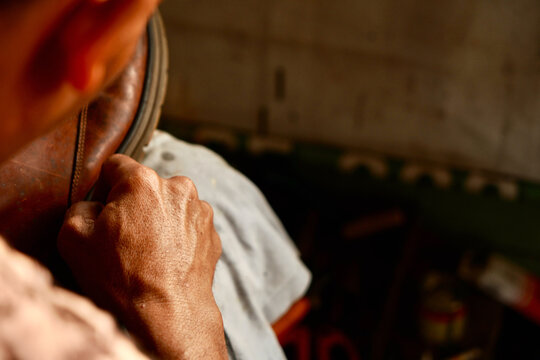 Cobbler Hands Sewing Shoe
Close-up shot of a skilled cobbler hands manually sewing a leather shoe with a needle and thread in a traditional workshop, highlighting artisan