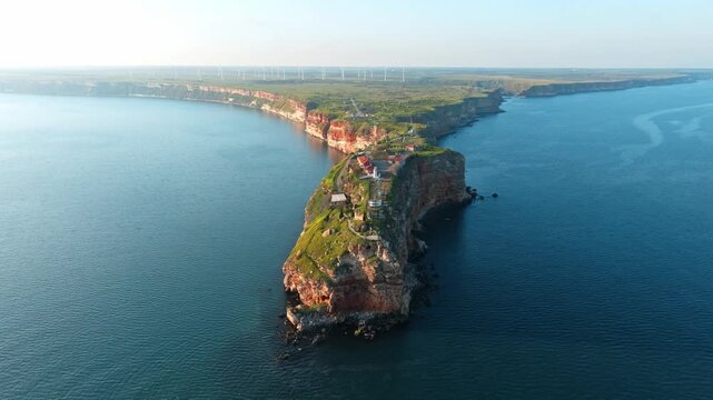 Cape Kaliakra aerial view of rocky headland cliffs on Black Sea coast Bulgaria drone footage summer travel destination landmark wind turbines