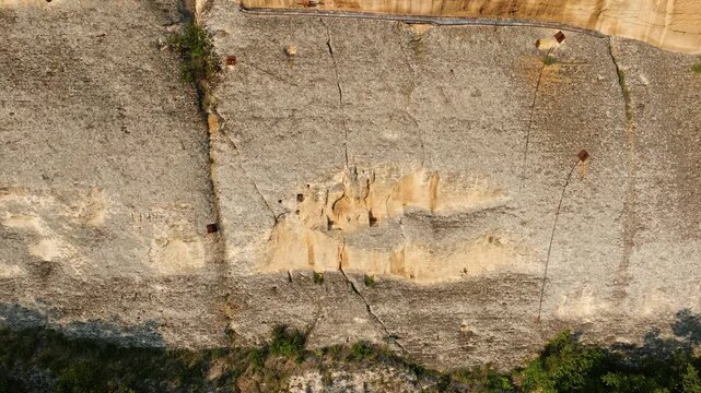 Madara Rider cliff aerial close up of ancient rock niches carved in limestone cliff face Bulgaria drone footage travel heritage site texture