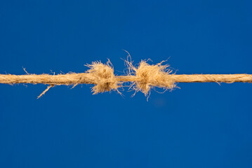 fraying rope on blue background © saturno