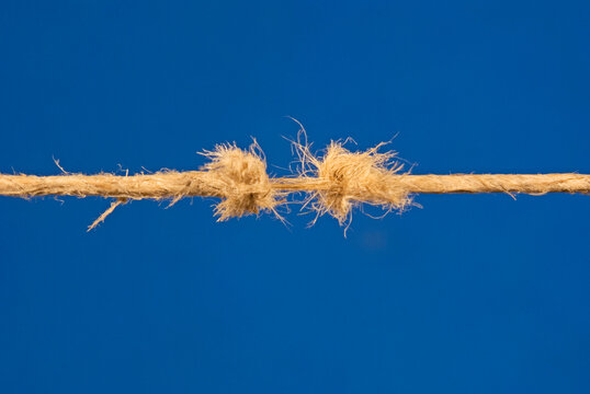fraying rope on blue background