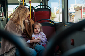 Mother and child traveling on city bus together © MexChriss