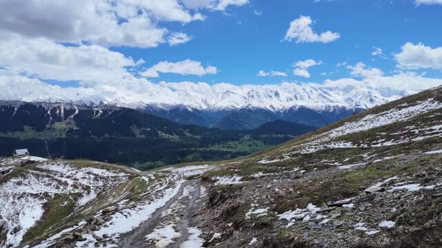 Panoramic view from Koruldi ridge in Svaneti, Caucasus mountains, snow capped peaks, alpine meadow, dramatic valley, georgia landscape