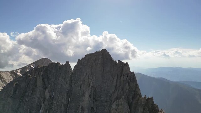 Vertical Drone Descent Over Mount Mytikas Summit Above the Clouds Mount Olympus Greece