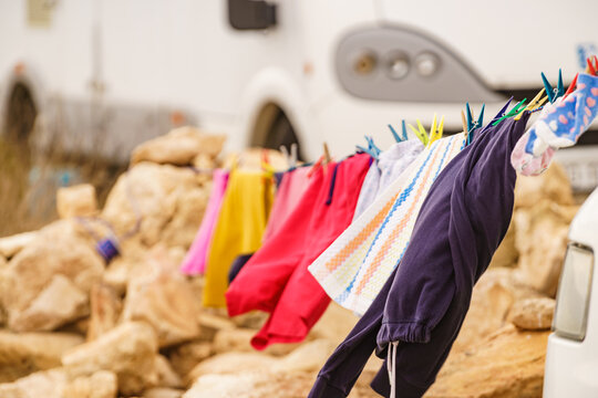 Washing laundry hanging to dry outdoors at caravan. Camping on nature, lifestyle.