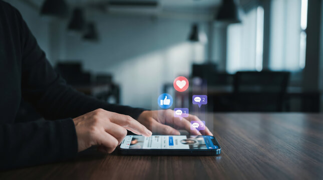 Person using a smartphone to engage with social media content featuring floating like and comment notification icons