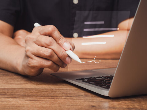 Person signing electronic document on laptop with stylus