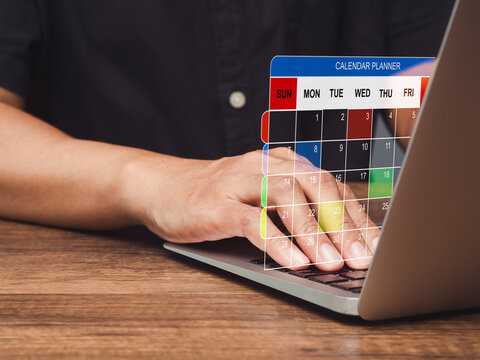 Hand typing on laptop with digital calendar planner overlay