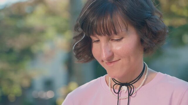 Student woman focused on studying outdoors in park close up