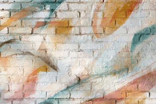 Abstract colorful paint strokes overlaying a textured white brick wall background, modern art.