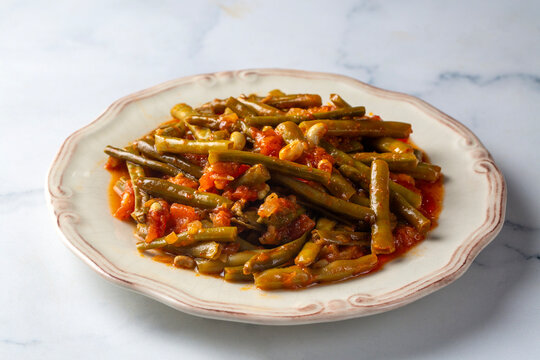 Traditional Turkish zeytinyagli taze borulce green black eyed peas stew on white plate