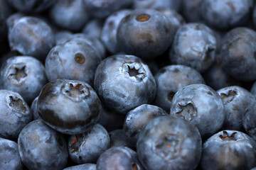 Blueberries. Close-up of juicy, ripe blueberries. Abstract nature background. Sweet berries harvested by a farmer in a summer garden. Food. Vitamins. Beautiful dark blue blueberry texture. © Татьяна Сычёва