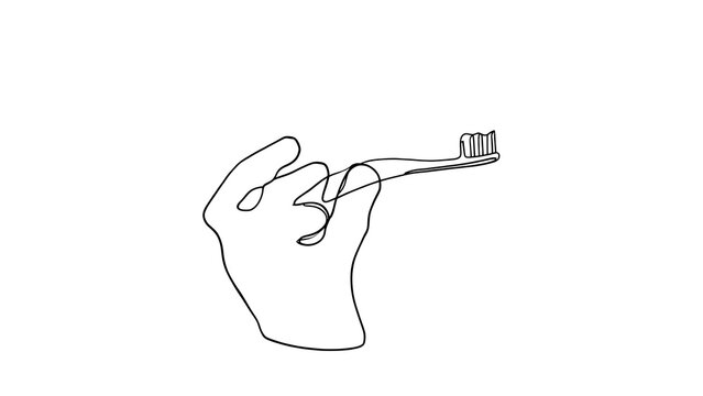 Hand holding toothbrush on white background.