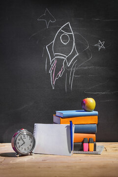 Checklist and  school supplies on table and blackboard front. Back-to-school shopping concept.