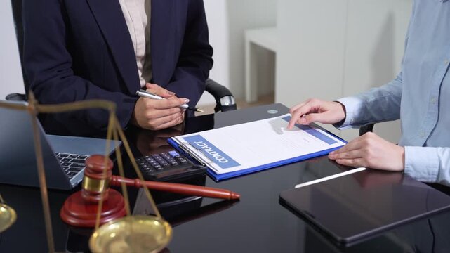 HR manager and legal advisor review remote work policy on laptop, ensuring legal compliance, employee governance, and modern workplace regulations.