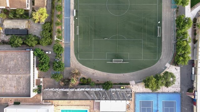 Urban sports complex aerial view football field and tennis courts community recreation and healthy lifestyle concept drone shot