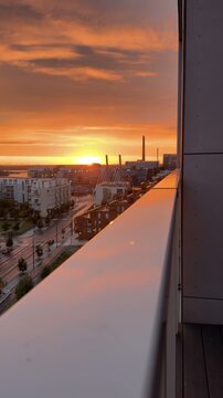 Orange Sunset over Helsinki City from Rooftop Balcony