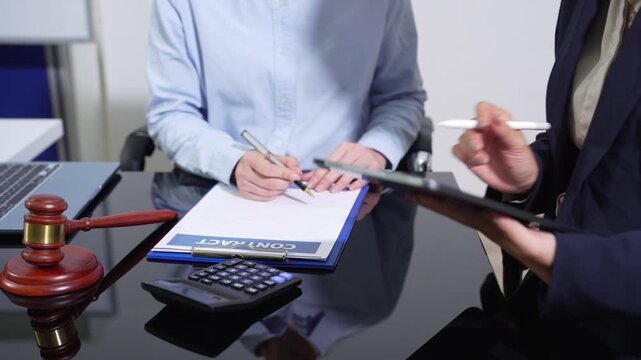 HR manager and legal advisor review remote work policy on laptop, ensuring legal compliance, employee governance, and modern workplace regulations.