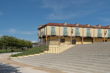Row of Yellow Balconied Houses Overlooking Wide Stone Steps and Park Pathway © Toyakisfoto.photos