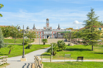 Historic Spanish Palace Facade with Clock Tower Overlooking a Landscaped Public Park © Toyakisfoto.photos