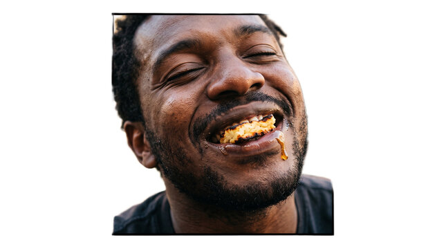 Middle-aged man laughing with mouth full of food. Joyful male enjoying a hearty meal in close-up portrait.