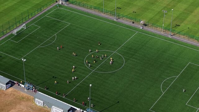 Aerial view of local amateur football match played on grass pitch in Redditch, UK