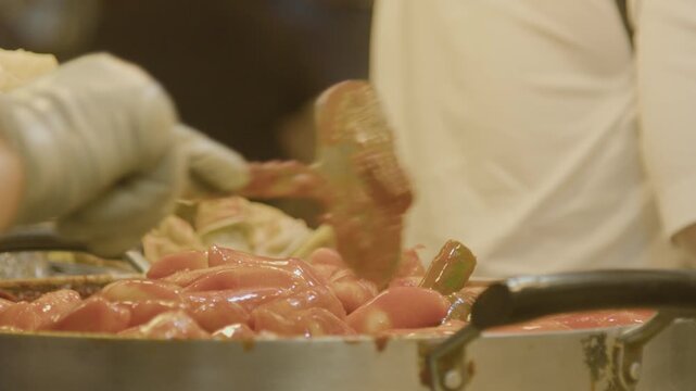 A market vendor cooking tteokbokki at Gwangjang Market, Seoul