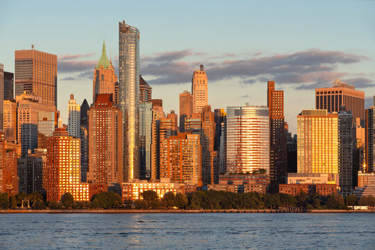Lower Manhattan skyline with Battery Park City skyscrapers at sunset viewed from Jersey City across the Hudson River. New York City