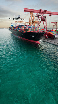 Container ship beside a busy cargo terminal