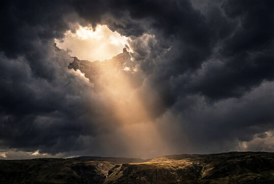 A powerful scene depicting sunlight streaming through an opening in dense dark storm clouds illuminating a textured desert landscape below during a moody sunset.