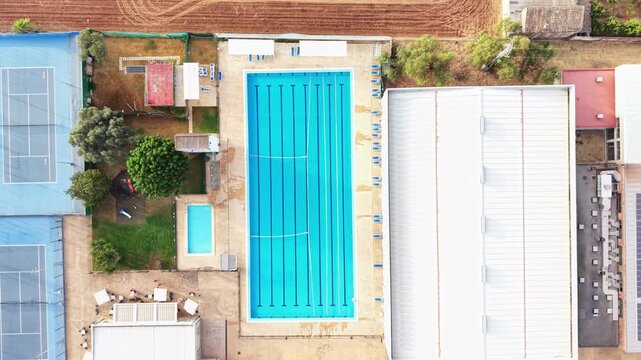 Aerial drone view of a sports complex with swimming pools tennis courts and solar panels leisure and recreation infrastructure
