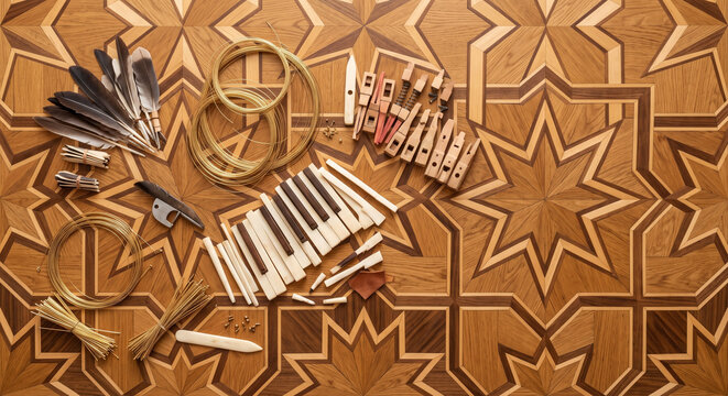 Top down flat lay of Baroque Harpsichord maintenance tools on parquetry floor