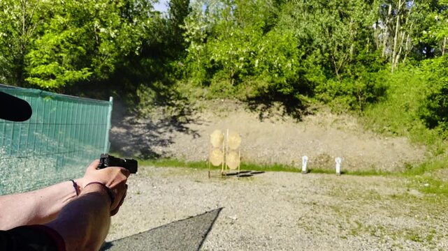 Man Training Shooting IPSC on a Stage with His Modern 9mm Handgun on Target in an Outdoor Shooting Range in a Sunny Day in Switzerland. (Audio)